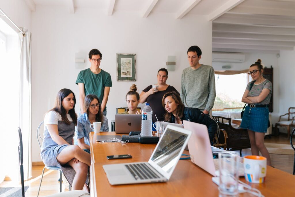 pexels-photo-1595385 Group of young professionals engaged in a collaborative meeting in a modern office setting.